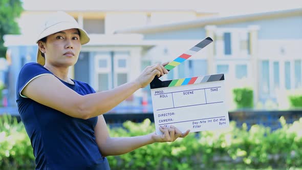 Woman Holding Cinema Slate alt