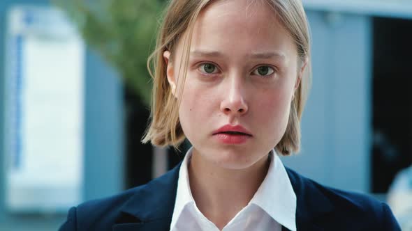 Front View of Blonde Female without Make-Up is looking at the Camera. alt