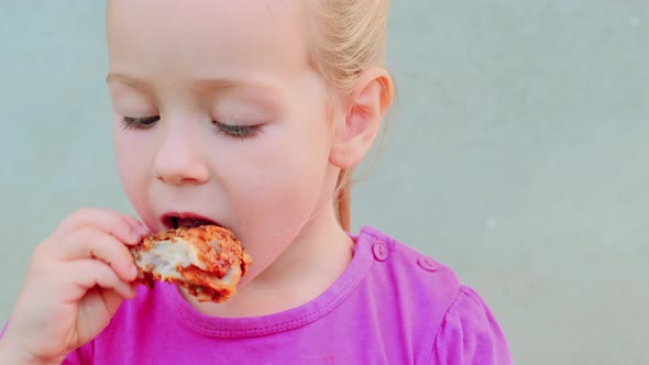 Portrait of a Pretty Little Kid Girl Eating Fried Crispy Crunchy Chicken Meat
