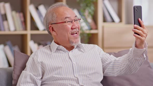 Asian elderly man making video call on smart phone, online call,  digital technology service consult alt