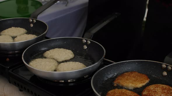 Traditional Pancakes on Frying Pan in Boiling Oil