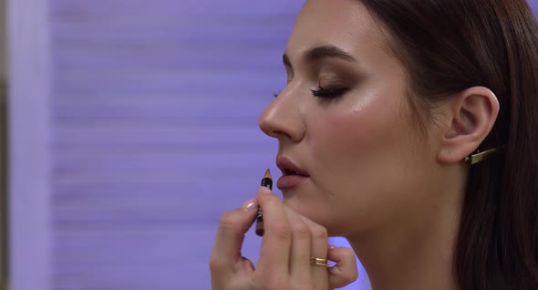 Girl Paints Her Lips With Lipstick
