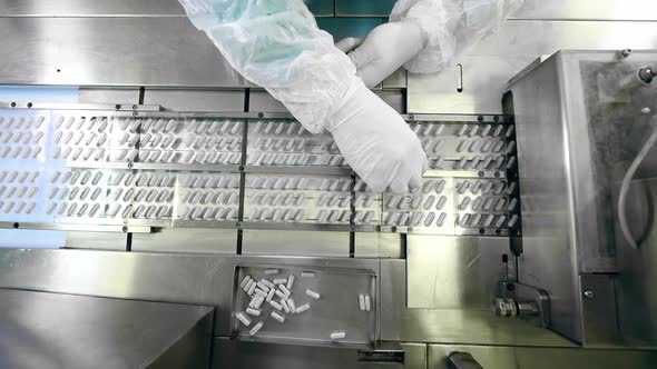 Top View of Medication Capsules Getting Replaced in Blisters alt