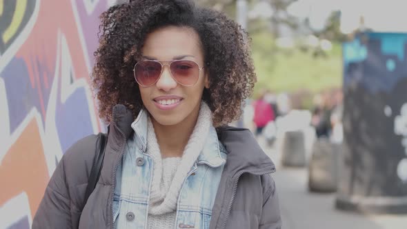 Beautiful Mixed Race Girl with Curly Hair Posing in Urban City Scenery alt