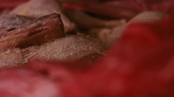 Closeup View of Hands in Gloves Packing Chicken Legs From a Box Into Individual Plastic Bags alt
