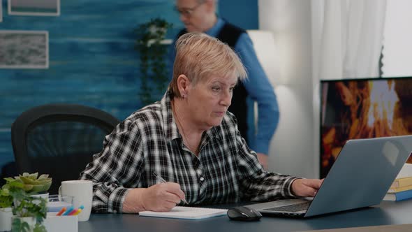 Old Woman Entrepreneur Checking Financial Project Taking Notes alt