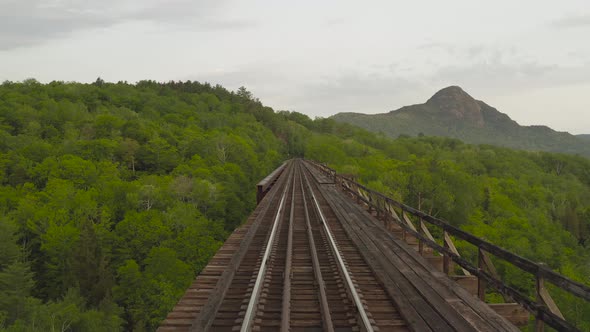 Aerial low angle Onawa trestle bridge railway tracks alt