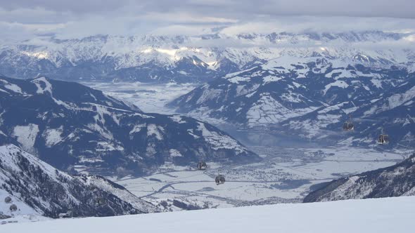 Gondola lifts riding over mountains alt