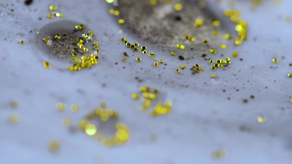 Macro Close Up Shot Of Golden Wet Glitter. Golden Space Glittering Particle Background.  alt