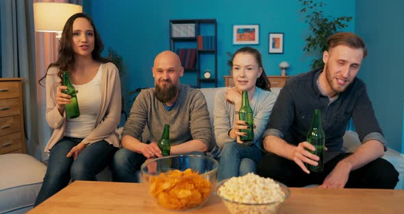 A Group of Good Friends From College are Relaxing on the Couch in the Evening alt