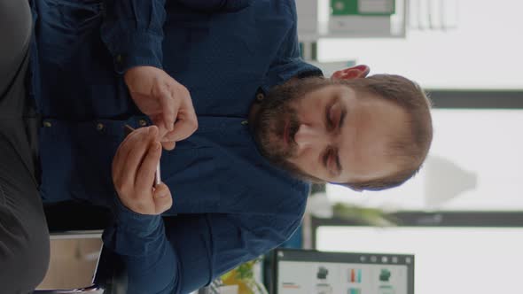 Video Vertical Handicapped Young Employee Browsing on Smartphone During Worktime alt