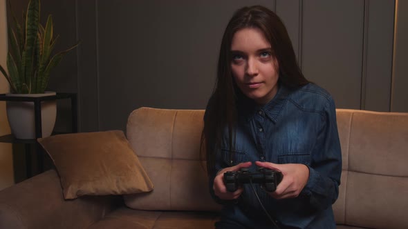 Woman Playing a Video Game at Home alt