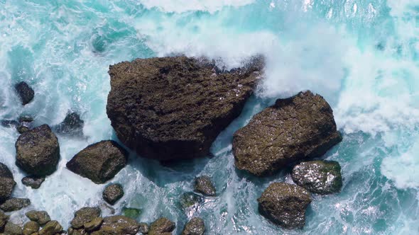 Top View of the Ocean Shore with Waves Crashing on Rocks
