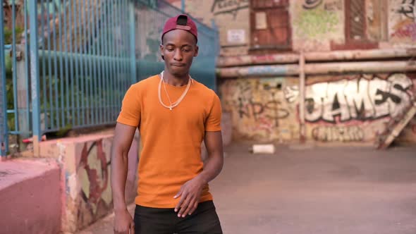 black guy dancing on the street in ghetto. dance of a young man on the street alt