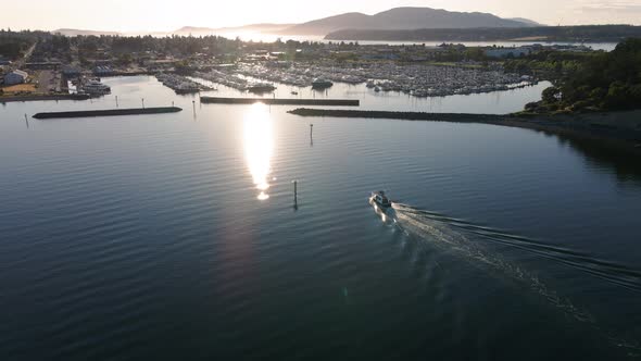 Drone Following Boat Pulling Into Marina With Amazing Lighting alt