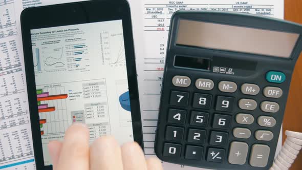 Businessman Working On The Tablet, Calculating Data And Calling By White Phone 