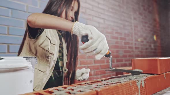 Young Girl Laying Bricks in Construction Theme alt
