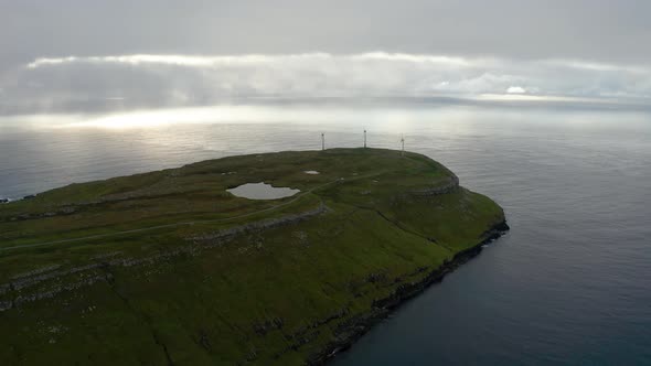 Aerial View of Wind Turbines on a Cape in Dramatic Weather alt