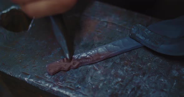 Medieval Blacksmith is Decorating Handle of Knife Closeup View in Forge  Prores alt