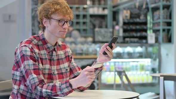 Successful Online Shopping Payment on Smartphone By Redhead Man  alt