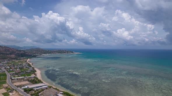 Magical view of moving dense clouds over calm sea with low tides. Aerial hyperlapse. Vietnam alt
