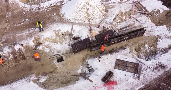 Engineers Work with Metal Constructions While Building a House alt