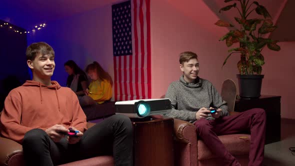 Cheerful Gamers with Joysticks Playing Video Game