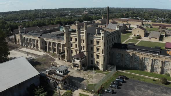 Aerial view of the derelict and abandoned Joliet prison or jail, a historic place. Drone slowly flyi alt
