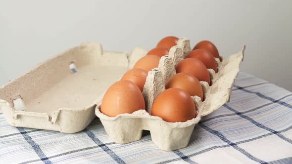 Row of Chicken Eggs and One Egg Open
