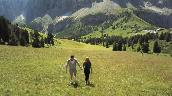 Man and woman hiking in mountain landscape, Alta Badia, Italy