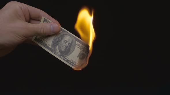 Incineration Of $ 100 Bills On A Black Background. Slow Mo 3