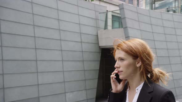 Businesswoman using smart phone and on the move