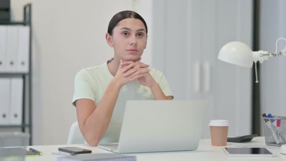 Pensive Young Latin Woman Thinking at Work alt