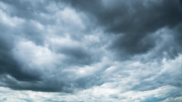 Timelapse Gray Rainy Clouds Float Across the Dark Sky on a Cloudy Day alt