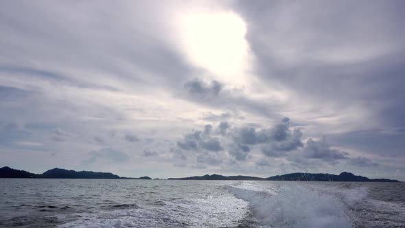 Clouds and Trace Behind the Stern of a Motor Boat