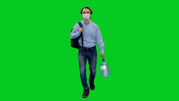 Casual Man in Protective Mask Stepping with a Backpack and Canister of Water