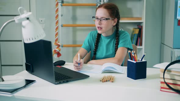 Schoolgirl Taking Part in an Online Class From Home. Online Education Concept. alt