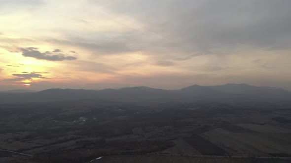Warm colors of dawn above the mountains Deli Jovan and Stol 4K drone video