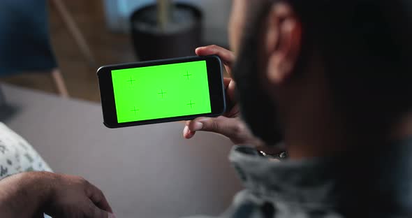 Man Touching Greenscreen Smartphone