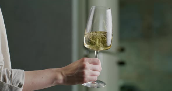 Glass of White Wine in a Woman's Hand