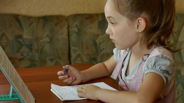 A Cute Little Girl is Doing Her Homework