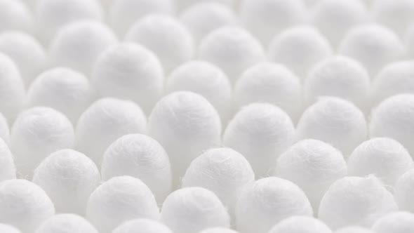 Closeup Spinning Fullframe Macro Background of Cotton Earbud Heads alt