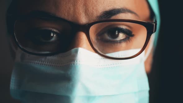 Young female medic, wearing a mask and glasses