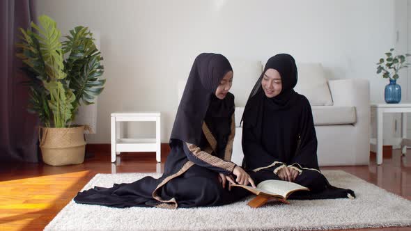Pretty Muslim women learning about Quran together alt