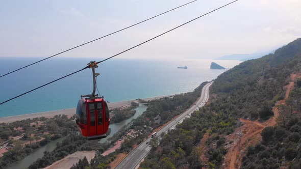 Close-up Flight Next To the Uphill Funicular with the Coast in the Background 