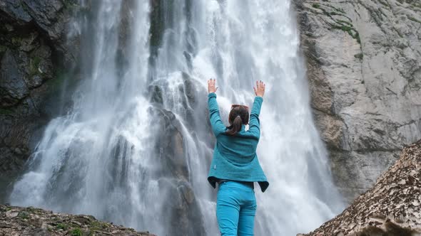 Woman Tourist Enjoying the Beauty of Waterfall alt