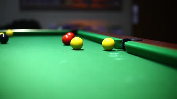 Balls on a green table during a billiards match