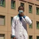 confident black doctor pulling down his mask and smiling at the camera - VideoHive Item for Sale
