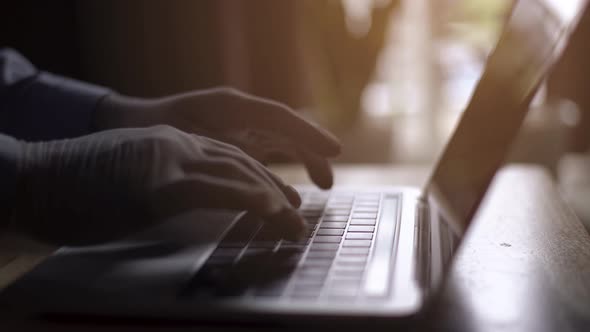 Businessman working on tablet computer,Extreme close-up human hands on keyboard hand type on laptop alt