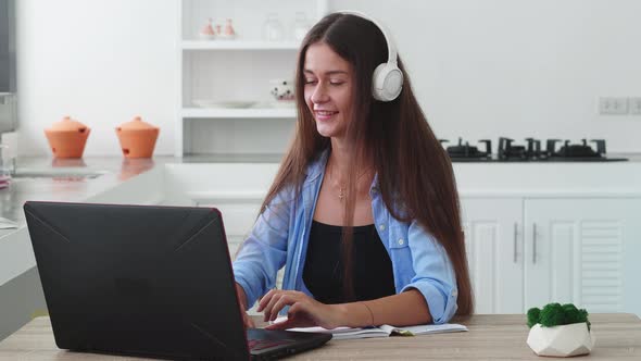 Woman in Headphones Have Chat Using Laptop alt